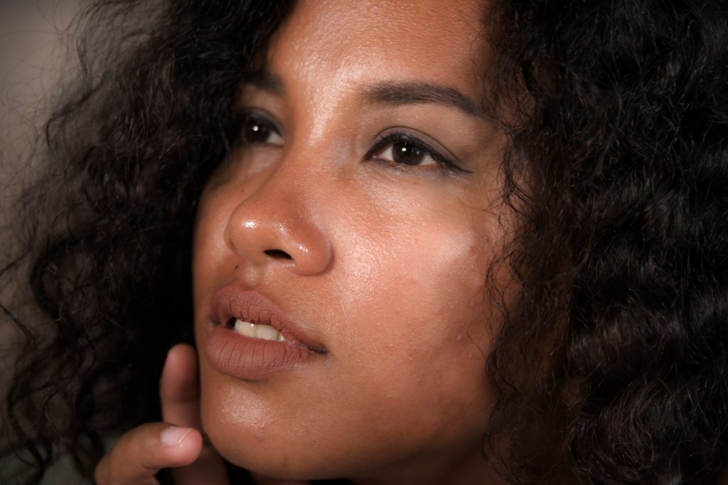 close up face portrait of young beautiful and exotic mixed ethnicity latin and afro American woman with expressive eyes in beauty concept